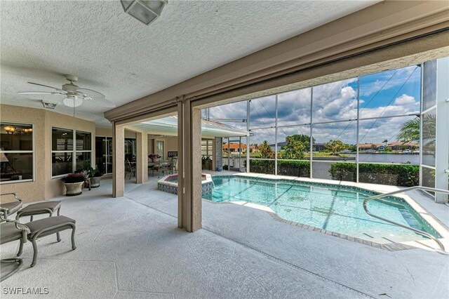 414 Caicos Dr, Punta Gorda, FL 33950 - view of swimming pool featuring a patio area, a ceiling fan, a pool with connected hot tub, and glass enclosure