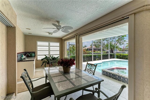 414 Caicos Dr, Punta Gorda, FL 33950 - sunroom / solarium with a hot tub, a sink, and a swimming pool
