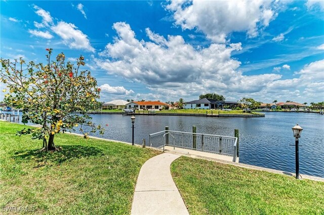 414 Caicos Dr, Punta Gorda, FL 33950 - dock area featuring a lawn, a water view, and a residential view