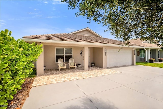 523 107th Ave N, Naples, FL 34108 - ranch-style house featuring stucco siding, a garage, and concrete driveway