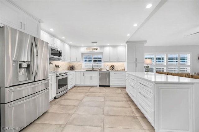 523 107th Ave N, Naples, FL 34108 - kitchen with appliances with stainless steel finishes, a sink, plenty of natural light, decorative backsplash, and recessed lighting