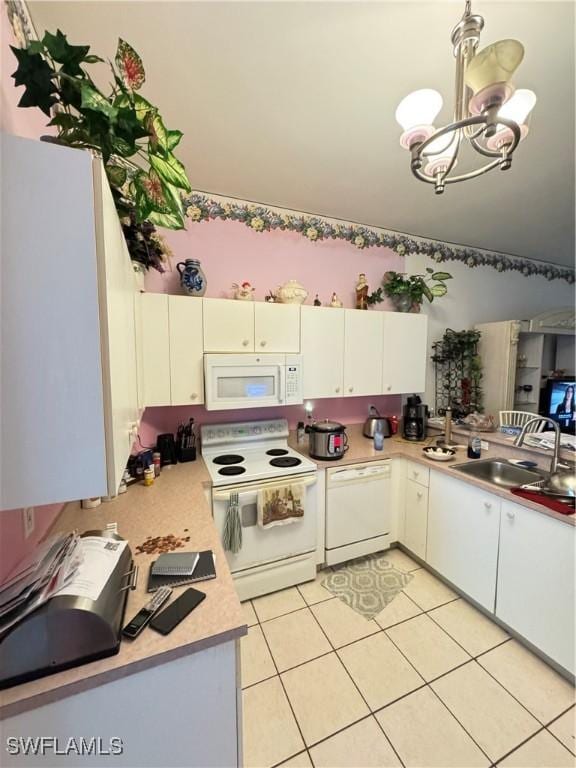 3430 Allegheny Ct, Naples, FL 34120 - kitchen featuring white appliances, a sink, a chandelier, light countertops, and light tile patterned flooring