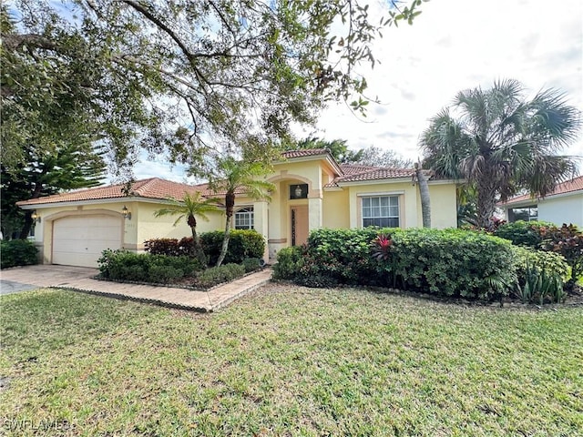 3430 Allegheny Ct, Naples, FL 34120 - mediterranean / spanish home featuring stucco siding, a tile roof, a garage, and a front lawn