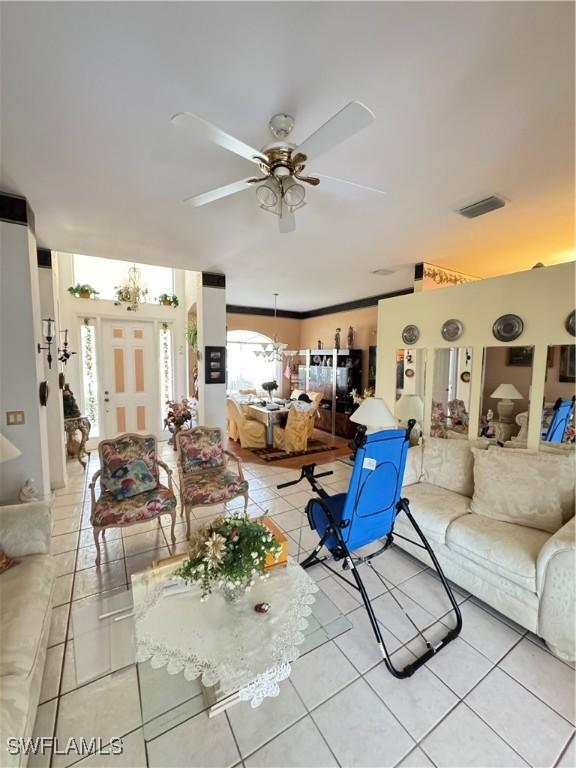 3430 Allegheny Ct, Naples, FL 34120 - living room with light tile patterned floors and ceiling fan