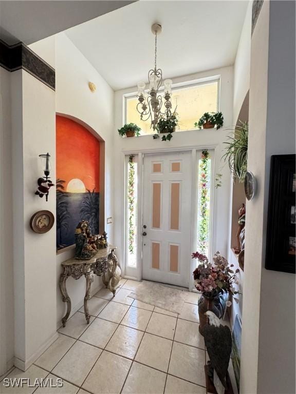 3430 Allegheny Ct, Naples, FL 34120 - foyer entrance with light tile patterned floors, a chandelier, and a towering ceiling