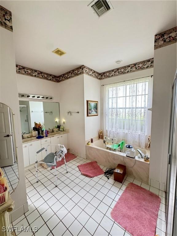 3430 Allegheny Ct, Naples, FL 34120 - bathroom featuring a bath, vanity, and tile patterned flooring