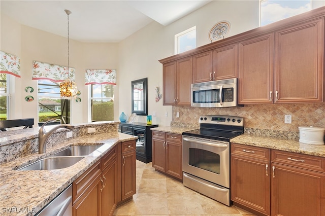 6492 Caldecott Dr, Naples, FL 34113 - kitchen featuring appliances with stainless steel finishes, a sink, plenty of natural light, backsplash, and a towering ceiling