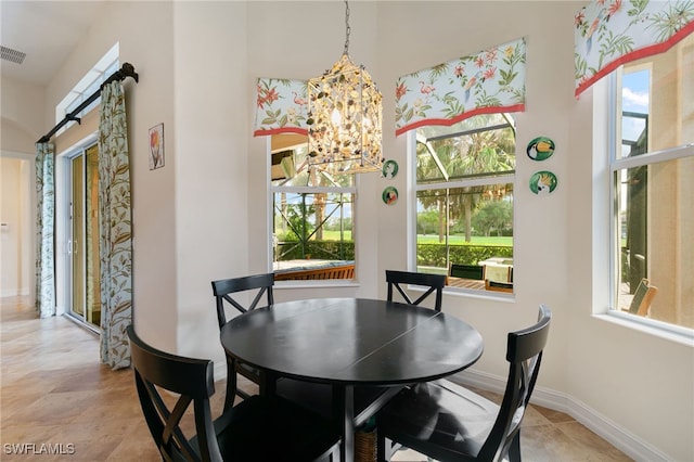 6492 Caldecott Dr, Naples, FL 34113 - dining space with a chandelier, plenty of natural light, baseboards, and a high ceiling