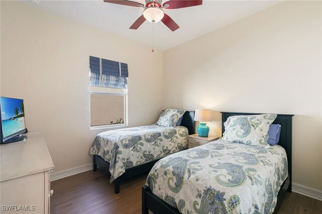 6492 Caldecott Dr, Naples, FL 34113 - bedroom featuring baseboards, wood finished floors, and a ceiling fan