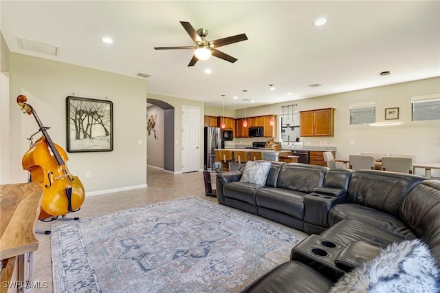 6624 Palmerston Dr, Fort Myers, FL 33966 - living room with baseboards, a ceiling fan, arched walkways, and recessed lighting