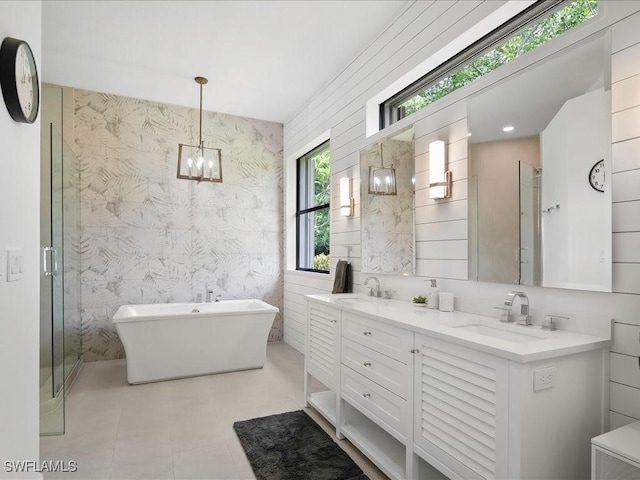 2360 19th St SW, Naples, FL 34117 - full bath featuring double vanity, a freestanding tub, a chandelier, wallpapered walls, and a shower stall