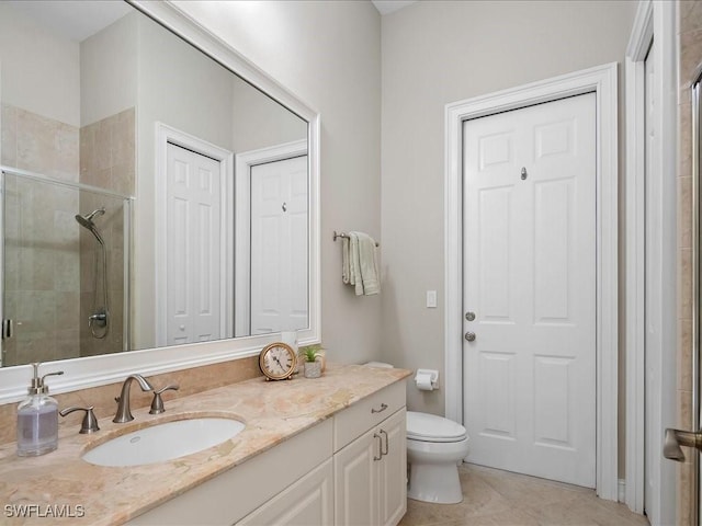 2360 19th St SW, Naples, FL 34117 - bathroom featuring vanity, a stall shower, toilet, and tile patterned flooring