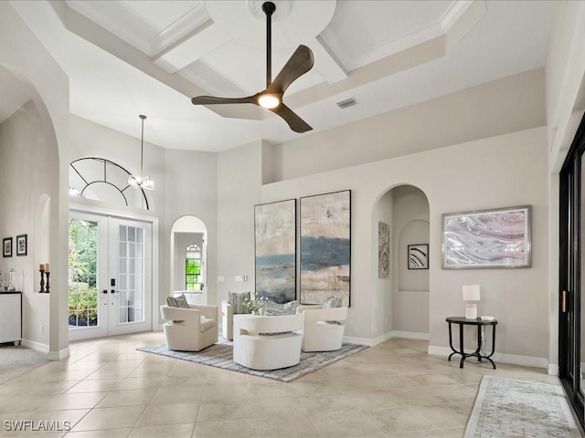 2360 19th St SW, Naples, FL 34117 - sitting room featuring arched walkways, a towering ceiling, a ceiling fan, french doors, and baseboards