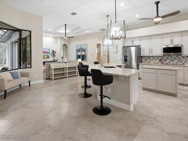 2360 19th St SW, Naples, FL 34117 - kitchen featuring appliances with stainless steel finishes, arched walkways, a ceiling fan, a sink, and recessed lighting