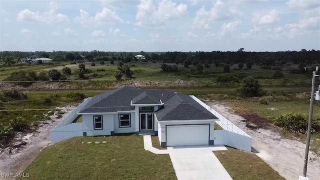 951 Commodore St, Lehigh Acres, FL 33974 - view of front of property with a garage, driveway, and roof with shingles
