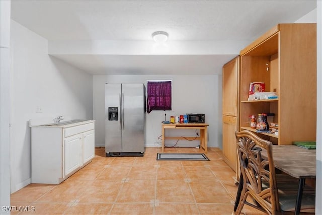 434 Leawood Cir, Naples, FL 34104 - kitchen with stainless steel fridge, light tile patterned floors, a sink, baseboards, and light countertops
