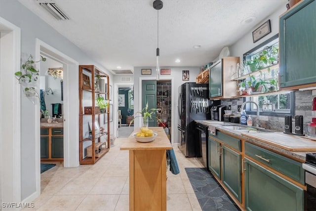434 Leawood Cir, Naples, FL 34104 - kitchen with a sink, wooden counters, black appliances, tasteful backsplash, and light tile patterned floors