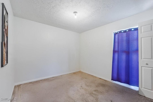 434 Leawood Cir, Naples, FL 34104 - carpeted empty room featuring a textured ceiling and baseboards