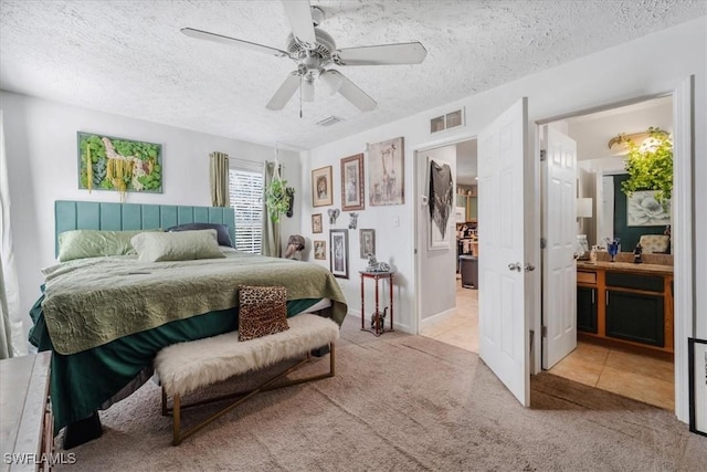 434 Leawood Cir, Naples, FL 34104 - tiled bedroom with carpet, a textured ceiling, ceiling fan, and ensuite bath