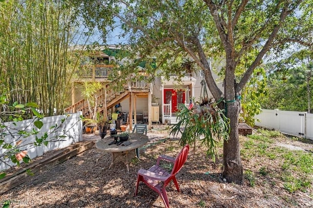 434 Leawood Cir, Naples, FL 34104 - fenced backyard featuring stairs, a gate, and a deck