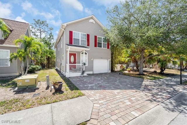 434 Leawood Cir, Naples, FL 34104 - view of front of property with decorative driveway and an attached garage