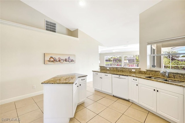 3317 SW 5th Pl, Cape Coral, FL 33914 - kitchen with white dishwasher, light tile patterned floors, stone counters, white cabinetry, and high vaulted ceiling