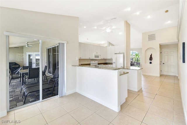 3317 SW 5th Pl, Cape Coral, FL 33914 - kitchen featuring ceiling fan, white appliances, a peninsula, light tile patterned floors, and high vaulted ceiling
