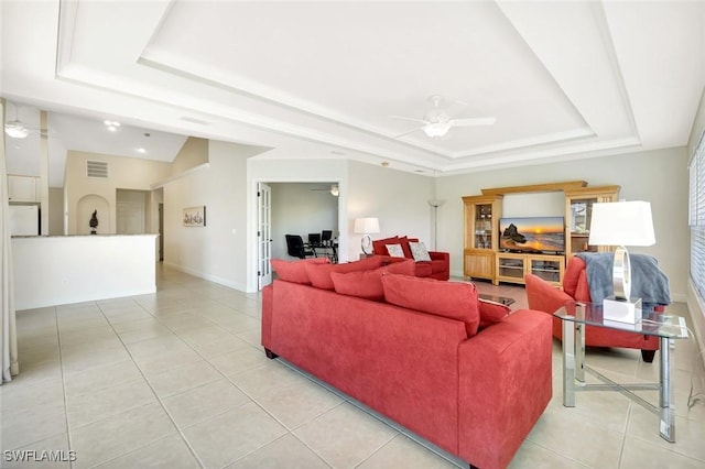 3317 SW 5th Pl, Cape Coral, FL 33914 - living room featuring a raised ceiling, light tile patterned floors, and a ceiling fan