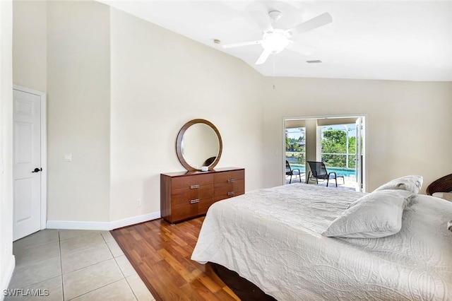 3317 SW 5th Pl, Cape Coral, FL 33914 - bedroom featuring access to exterior, lofted ceiling, light tile patterned floors, and a ceiling fan