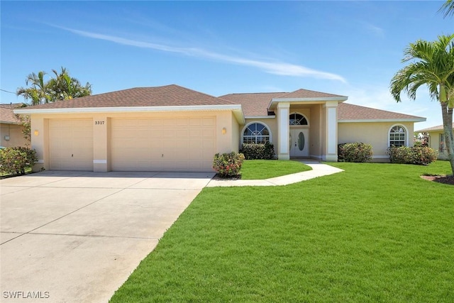 3317 SW 5th Pl, Cape Coral, FL 33914 - view of front facade featuring an attached garage, stucco siding, driveway, and a front yard