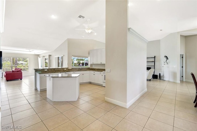 3317 SW 5th Pl, Cape Coral, FL 33914 - kitchen with open floor plan, light tile patterned flooring, white cabinetry, ceiling fan, and a center island