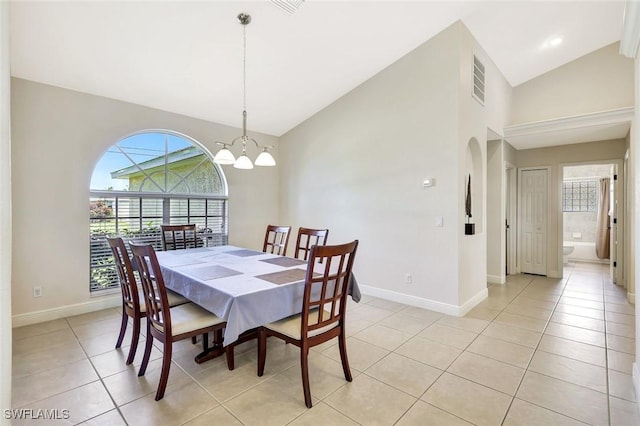 3317 SW 5th Pl, Cape Coral, FL 33914 - dining room featuring light tile patterned flooring, high vaulted ceiling, a chandelier, and arched walkways