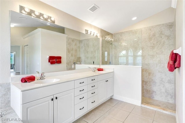 3317 SW 5th Pl, Cape Coral, FL 33914 - full bathroom featuring lofted ceiling, double vanity, tile patterned floors, and a walk in shower