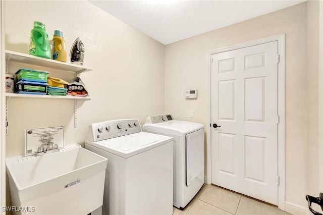 3317 SW 5th Pl, Cape Coral, FL 33914 - laundry room with washer and clothes dryer and light tile patterned flooring