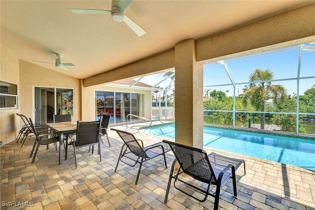3317 SW 5th Pl, Cape Coral, FL 33914 - view of patio with a ceiling fan, outdoor dining space, an outdoor pool, and glass enclosure