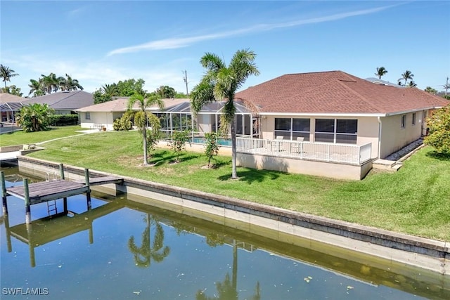 3317 SW 5th Pl, Cape Coral, FL 33914 - back of property with a water view, a lawn, glass enclosure, roof with shingles, and stucco siding