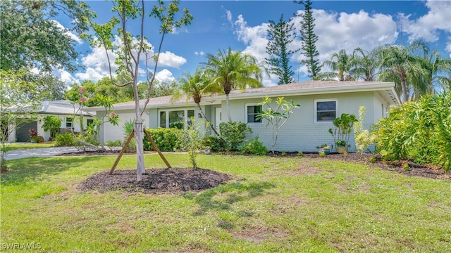 1682 S Flossmoor Rd, Fort Myers, FL 33919 - view of front facade featuring a front lawn, a garage, and stucco siding