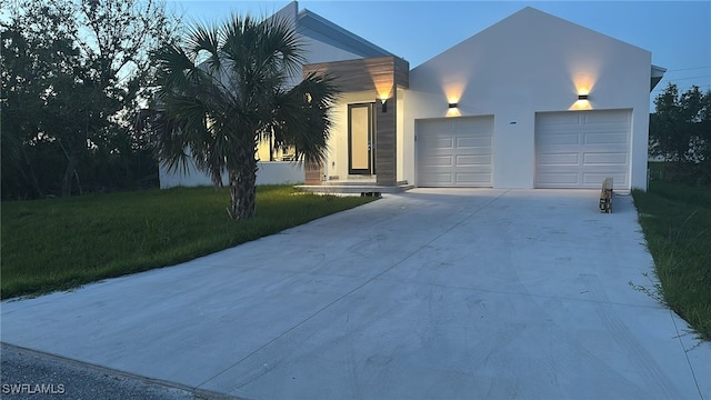 14074 Whittier Ln, Port Charlotte, FL 33981 - view of front of property featuring driveway, an attached garage, stucco siding, and a front yard