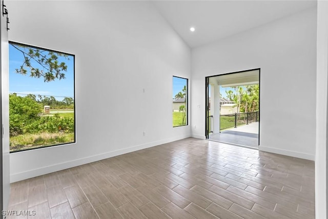 14074 Whittier Ln, Port Charlotte, FL 33981 - spare room featuring high vaulted ceiling, wood finished floors, and recessed lighting