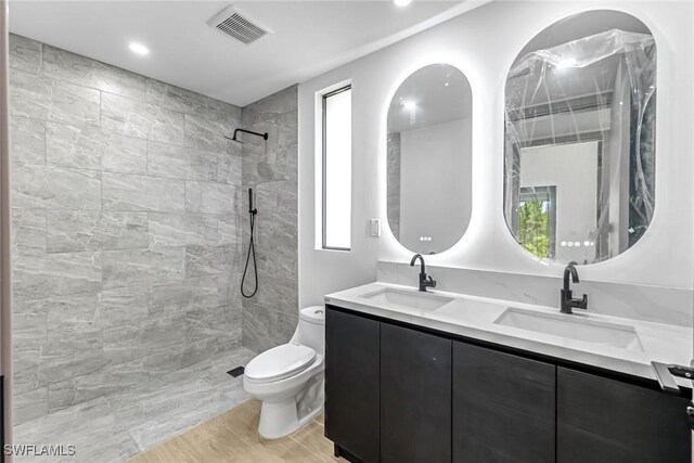 14074 Whittier Ln, Port Charlotte, FL 33981 - bathroom with double vanity, tiled shower, wood finished floors, and recessed lighting