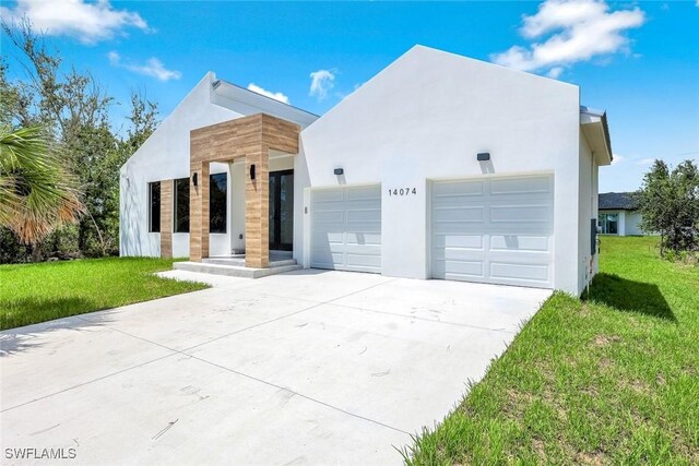 14074 Whittier Ln, Port Charlotte, FL 33981 - modern home with driveway, a front yard, stucco siding, and a garage