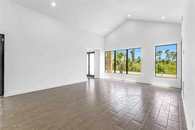 14074 Whittier Ln, Port Charlotte, FL 33981 - unfurnished room featuring high vaulted ceiling, wood tiled floors, and recessed lighting