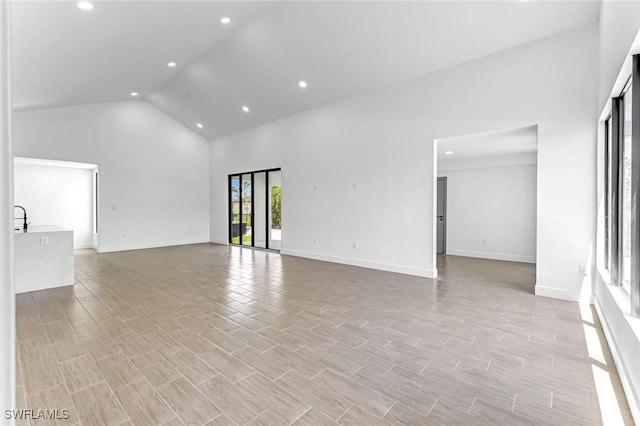 14074 Whittier Ln, Port Charlotte, FL 33981 - unfurnished room featuring high vaulted ceiling, recessed lighting, and light wood finished floors