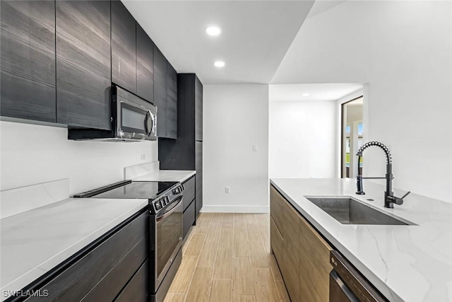 14074 Whittier Ln, Port Charlotte, FL 33981 - kitchen with appliances with stainless steel finishes, light wood finished floors, modern cabinets, recessed lighting, and light stone counters