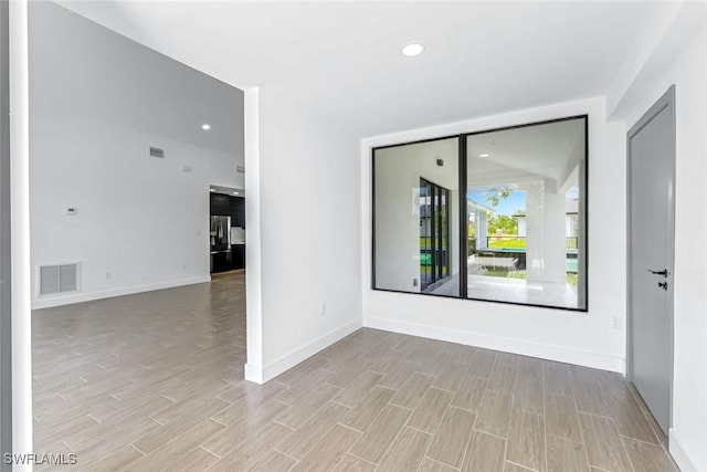 14074 Whittier Ln, Port Charlotte, FL 33981 - empty room with light wood-style flooring and recessed lighting