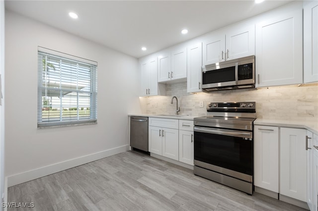 1830 Brantley Rd Unit A2, Fort Myers, FL 33907 - kitchen featuring appliances with stainless steel finishes, a sink, light countertops, decorative backsplash, and recessed lighting