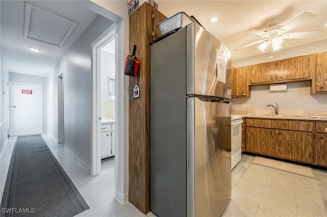 1830 Brantley Rd Unit A2, Fort Myers, FL 33907 - kitchen with freestanding refrigerator, white electric range, light countertops, ceiling fan, and brown cabinetry