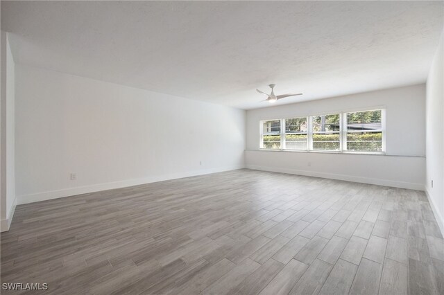1830 Brantley Rd Unit A2, Fort Myers, FL 33907 - empty room featuring wood finished floors, baseboards, and a ceiling fan