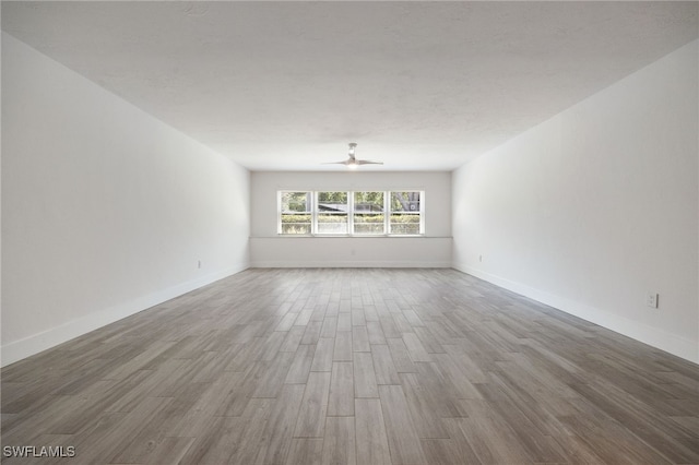 1830 Brantley Rd Unit A2, Fort Myers, FL 33907 - empty room with wood finished floors, a ceiling fan, and baseboards