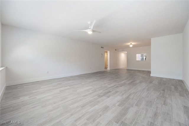 1830 Brantley Rd Unit A2, Fort Myers, FL 33907 - empty room with light wood-style floors, a ceiling fan, and baseboards